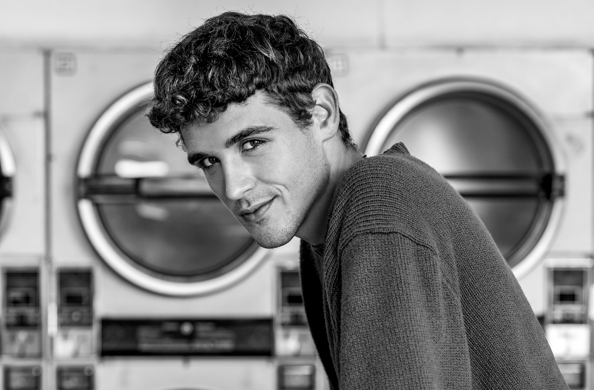 Man posing laundromat portrait