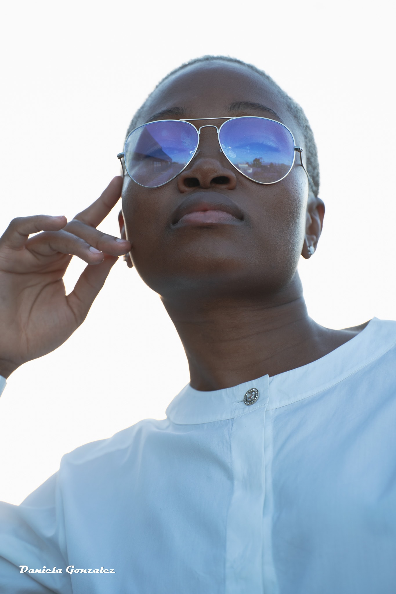 Person wearing blue aviator sunglasses fashion portrait