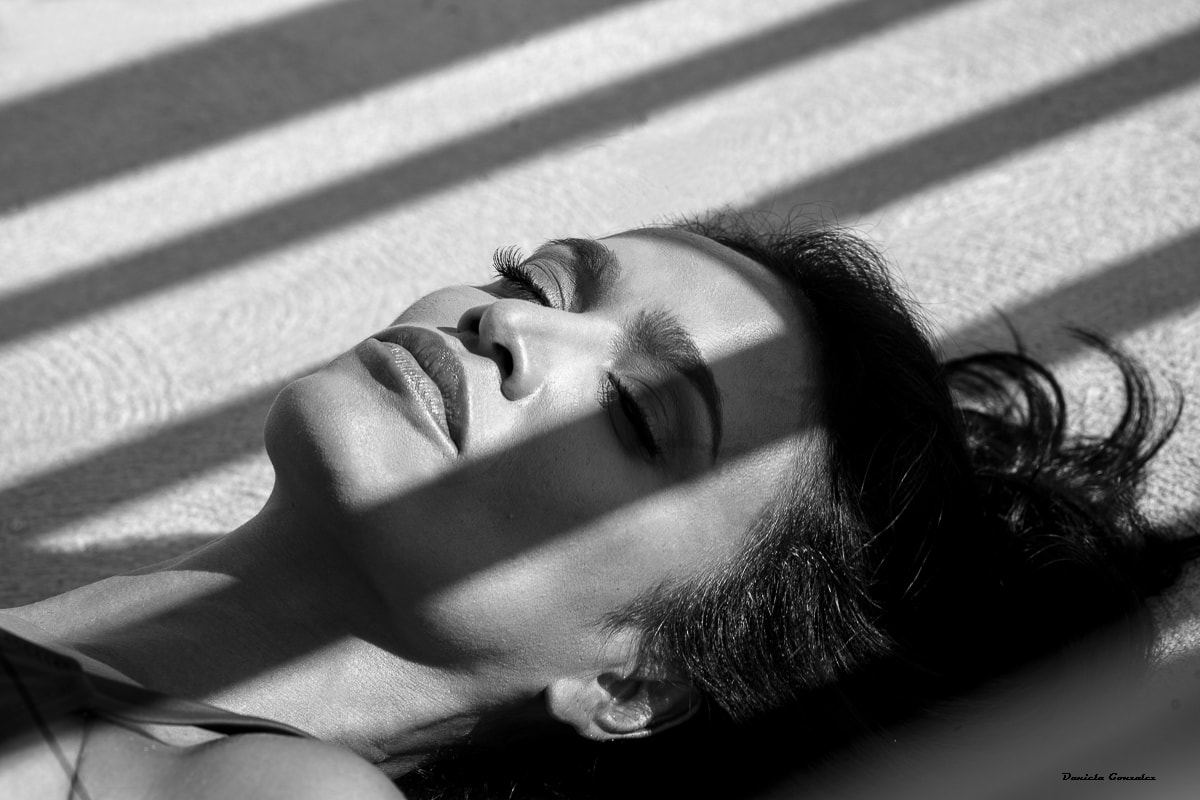 Woman smiling over shoulder black and white portrait
