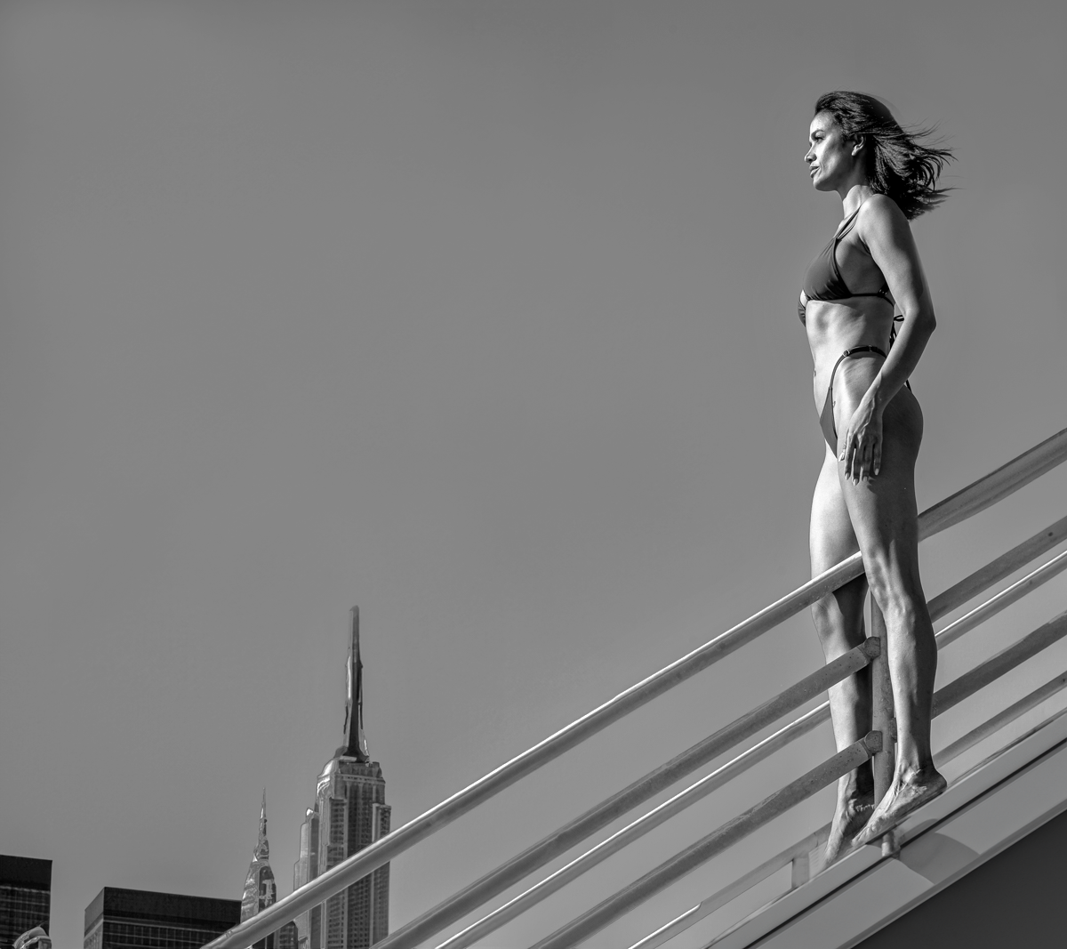 Woman on rooftop overlooking city
