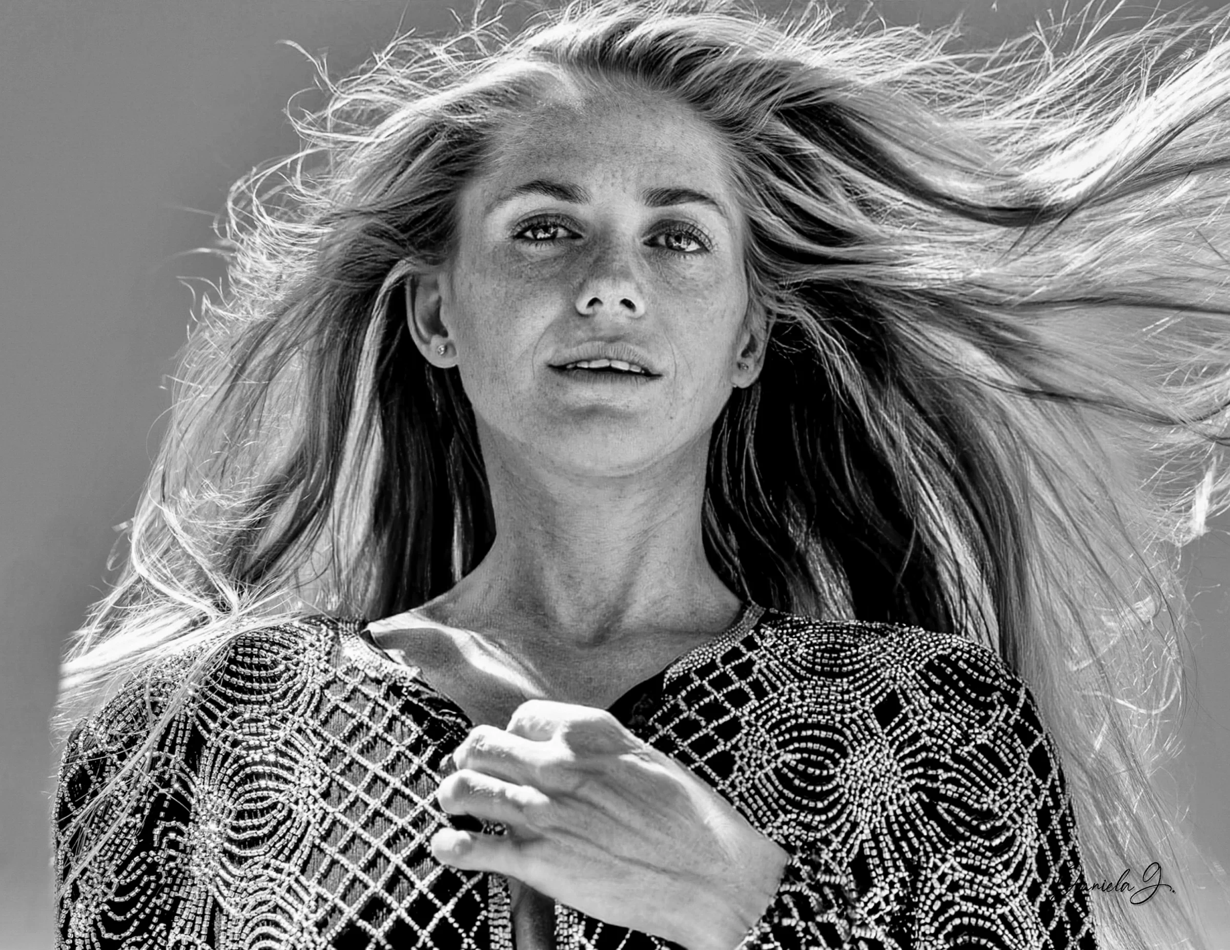Woman with flowing hair looking upward